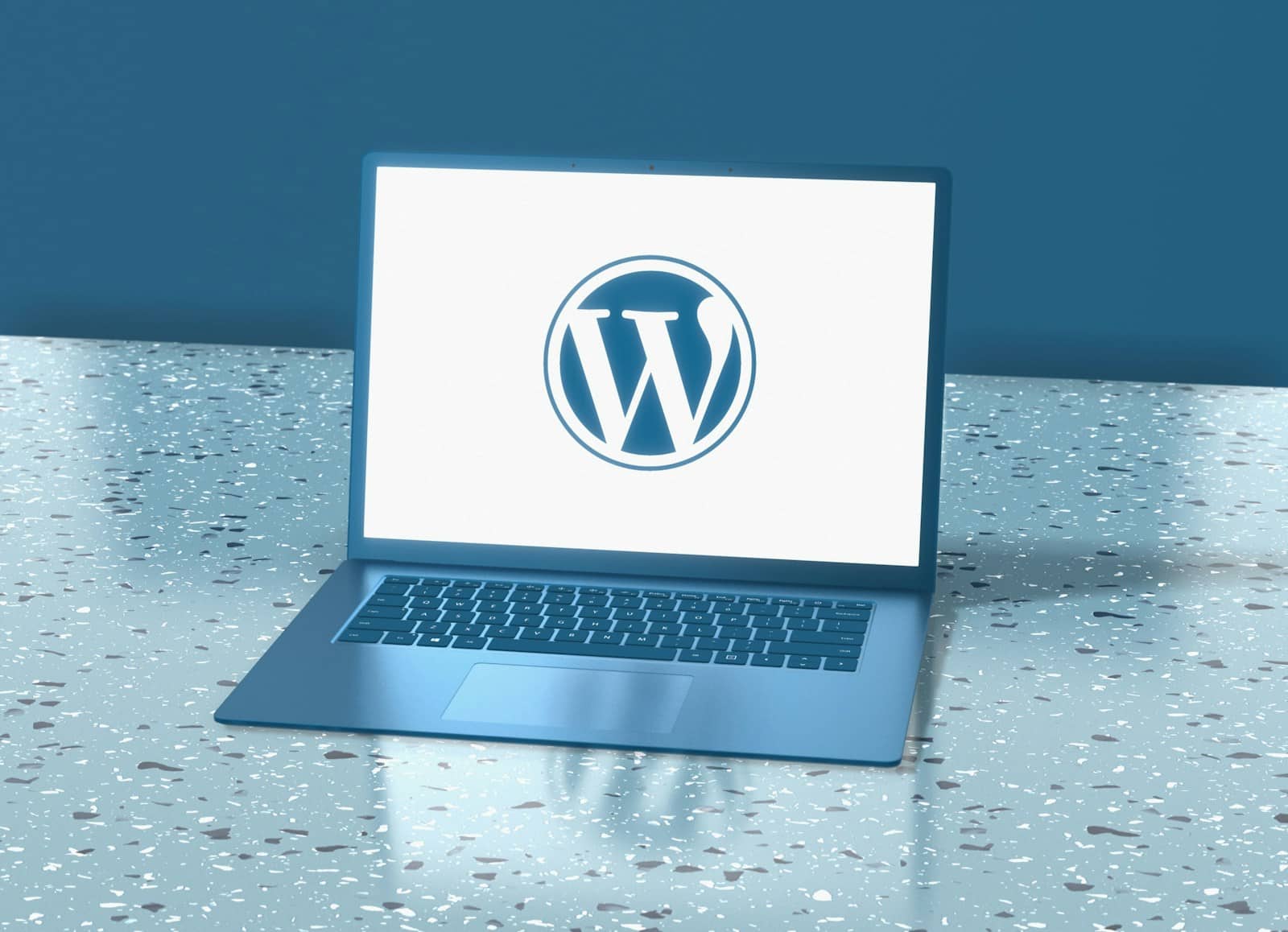 Photo by Choong Deng Xiang a laptop computer sitting on top of a table with the wordpress logo on it