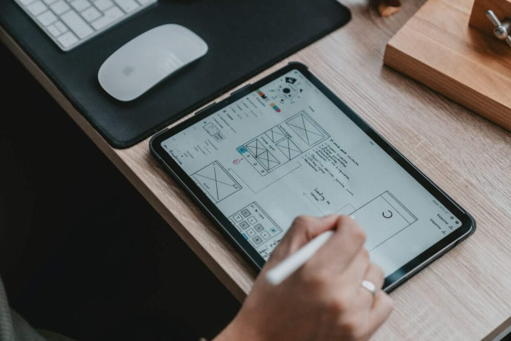 Photo by Alvaro Reyes The Benefits of Responsive Design person writing on white paper